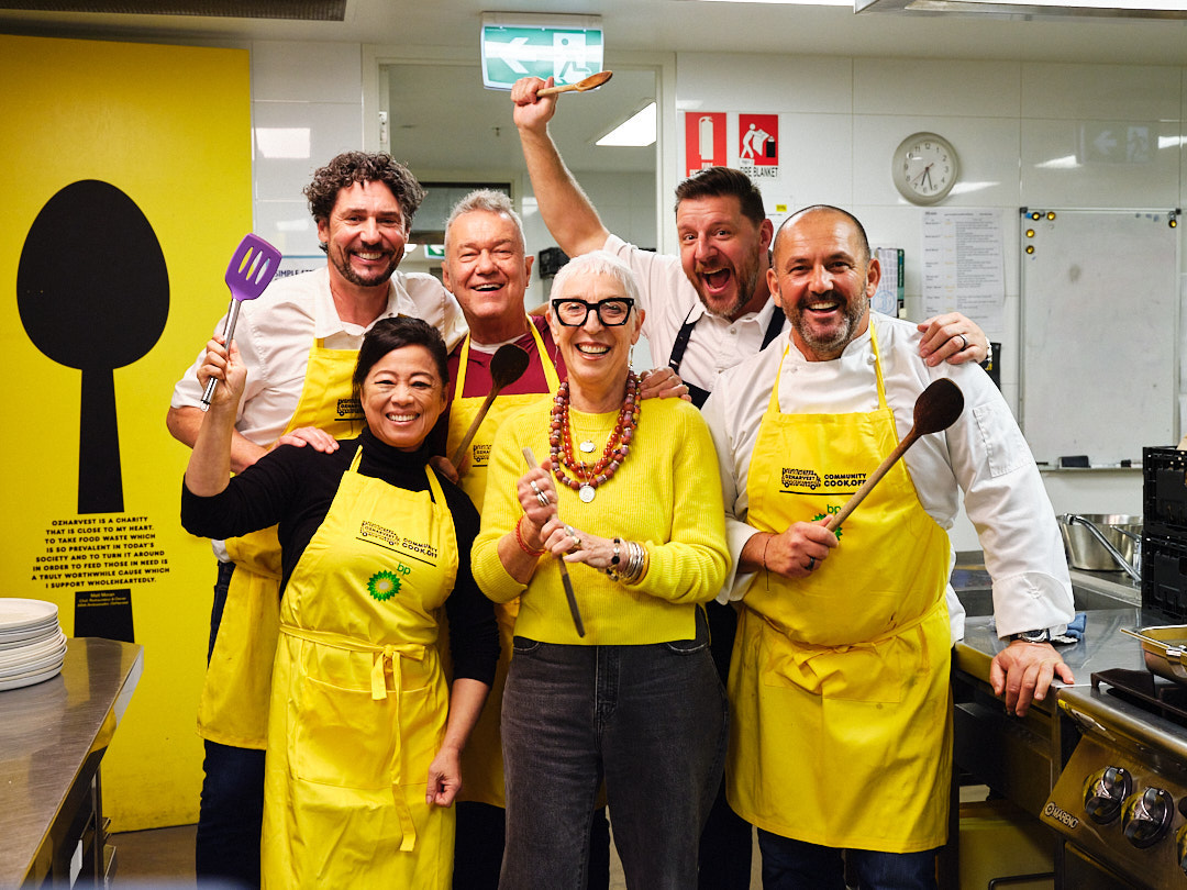Ronni Kahn AO, founder of OzHarvest with a group of chefs, business leaders, and volunteers all excited to help with the event.
