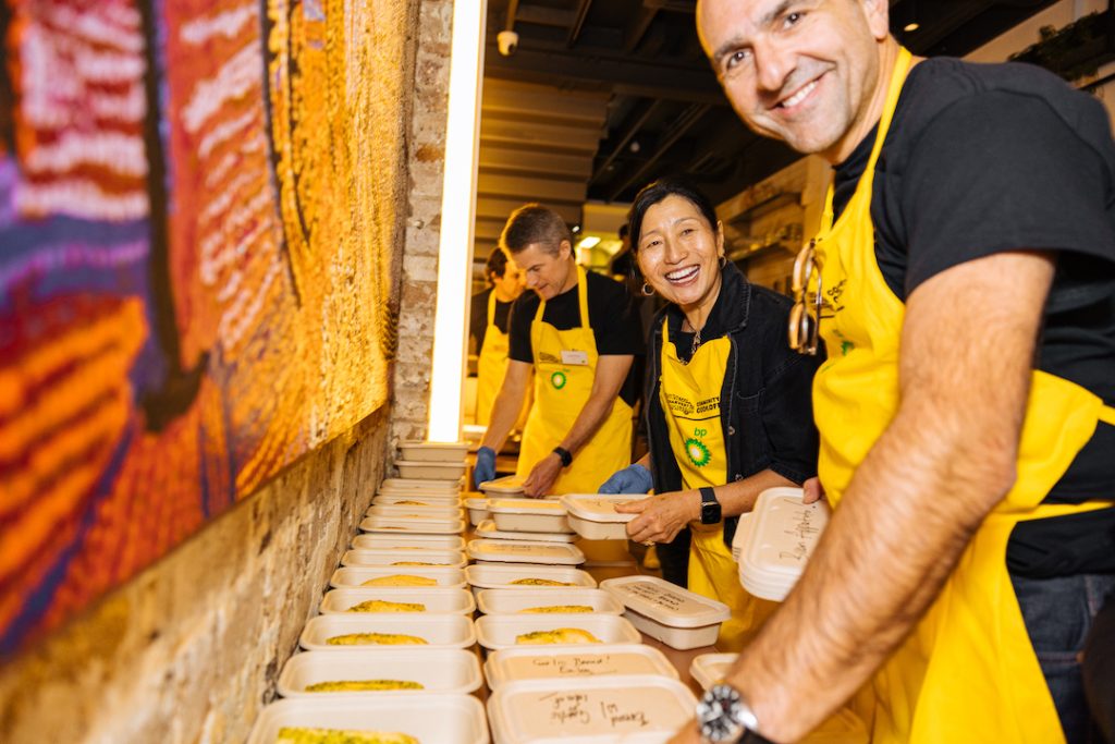 A group of business leaders packing up take away meals for the OzHarvest CEO CookOff.